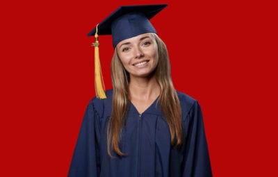 family photo - blonde graduate on red backdrop