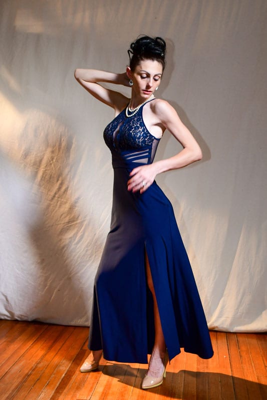 model abbie in blue dress looking down