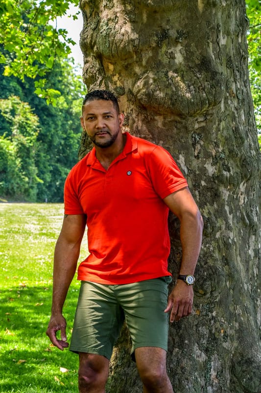 male model Olivier in red polo under tree