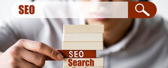 SEO blocks and search bar, selective focus of man touching the blocks
