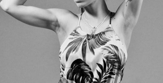 Kitti - Black and white photo of brunette model in floral dress