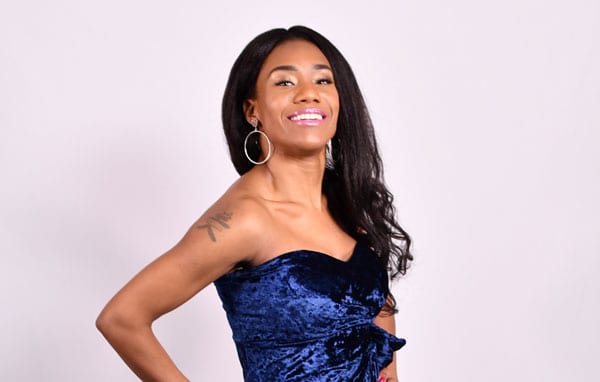 young woman in prom dress on white backdrop