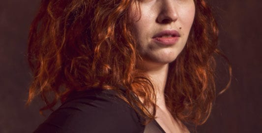 model amanda - side profile of model with curly red hair