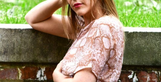 erica - blone model near brick wall with grass on top