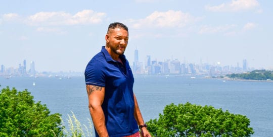 Male model Olivier with NYC cityscape behind.