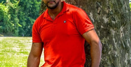 male model Olivier in red polo under tree